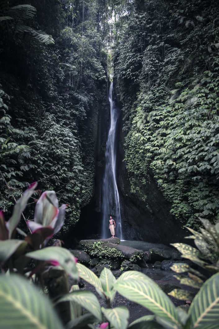 Man standing in front of Leke Leke Waterfalls in Bali
